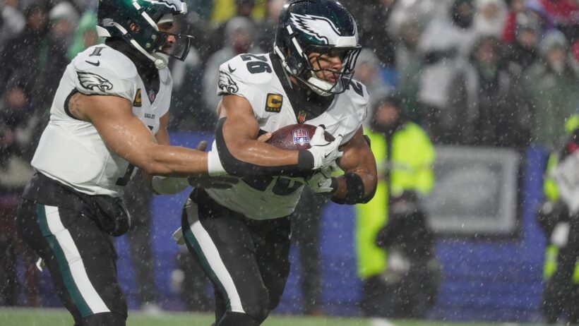 Saquon Barkley taking a handoff