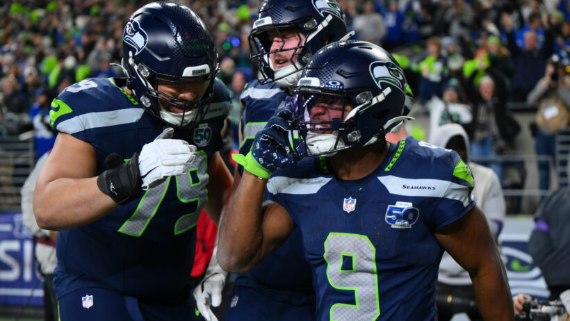 Kenneth Walker celebrating with teammates